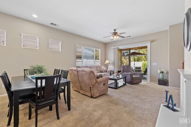 carpeted living room featuring ceiling fan