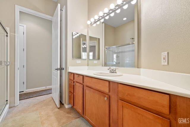 bathroom featuring tile patterned flooring, vanity, and an enclosed shower