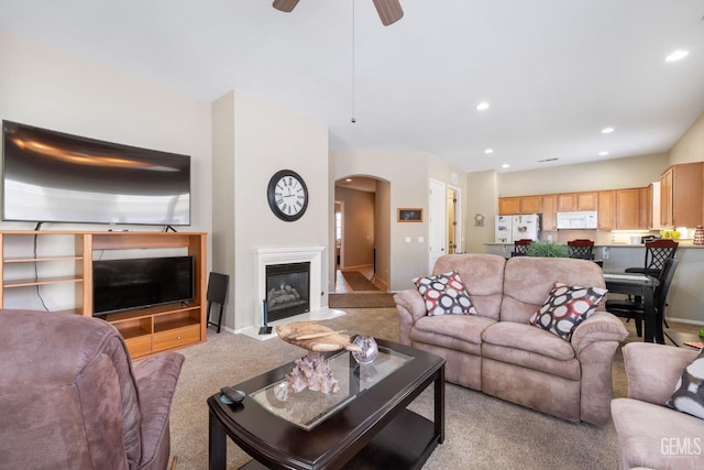 living room with ceiling fan and light colored carpet