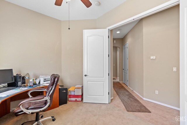 carpeted home office featuring ceiling fan