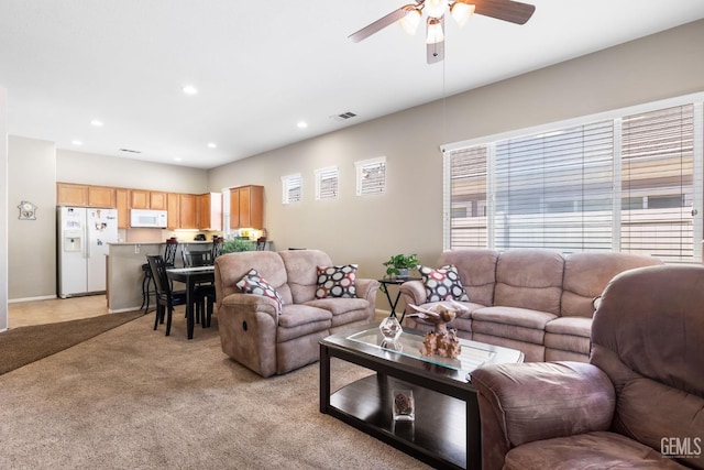 living room with light carpet and ceiling fan