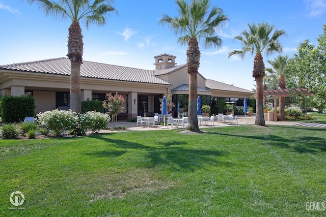 rear view of property with a yard