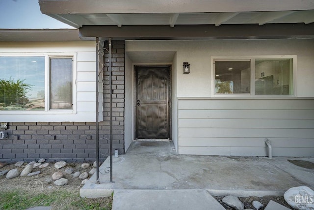 view of exterior entry with stone siding