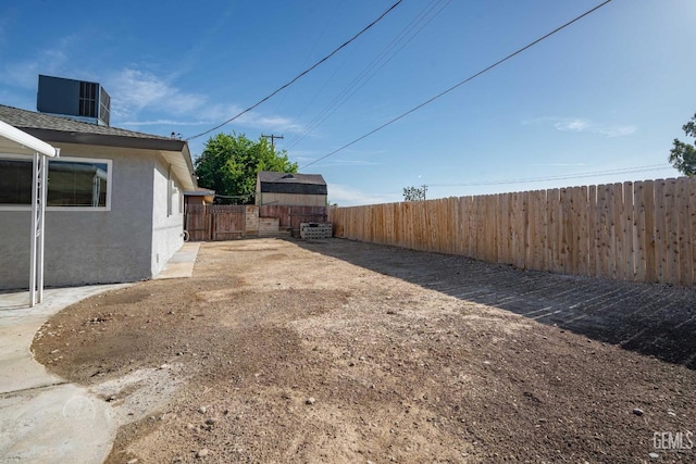 view of yard featuring an outbuilding and a fenced backyard