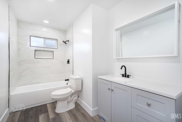 full bath featuring vanity, baseboards, toilet, shower / bathing tub combination, and wood finished floors