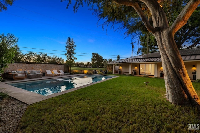 view of swimming pool featuring a lawn, an outdoor living space, a patio area, and a fenced in pool
