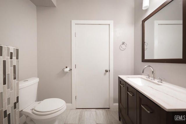 2200 Park Way, Bakersfield, CA 93304 - half bath featuring toilet, vanity, marble finish floors, and baseboards