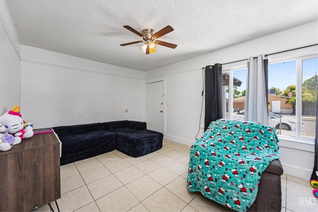 309 F St, Bakersfield, CA 93304 - living area featuring ceiling fan, a textured ceiling, and light tile patterned floors