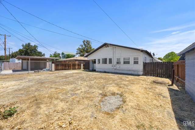 309 F St, Bakersfield, CA 93304 - rear view of house with a fenced backyard