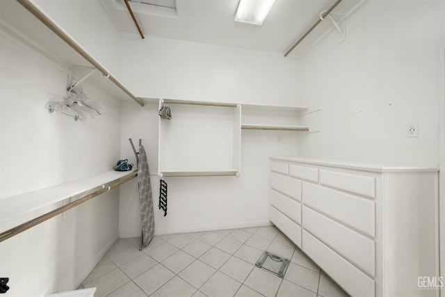 spacious closet with light tile patterned floors