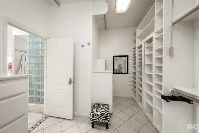 spacious closet with light tile patterned floors