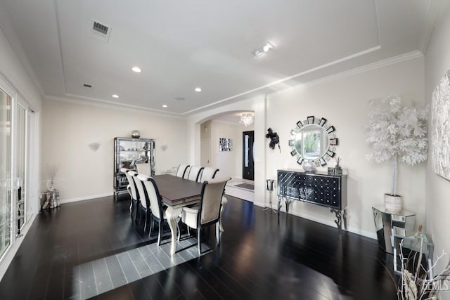 dining space featuring dark wood-type flooring and ornamental molding