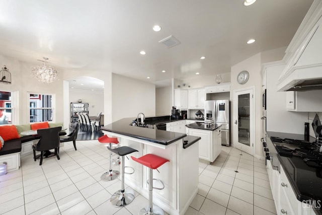 kitchen featuring white cabinetry, stainless steel appliances, sink, kitchen peninsula, and light tile patterned floors