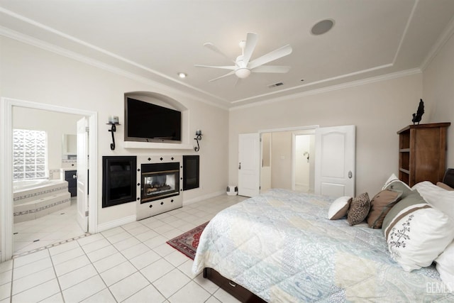 tiled bedroom with ceiling fan, crown molding, and connected bathroom