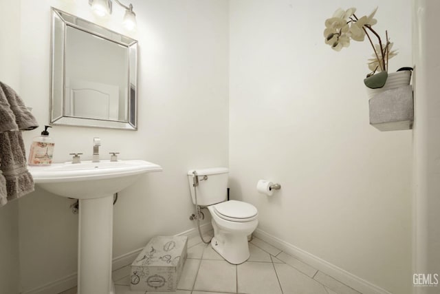 bathroom featuring toilet and tile patterned floors