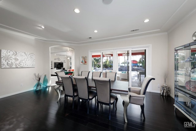 dining space with dark hardwood / wood-style flooring and crown molding