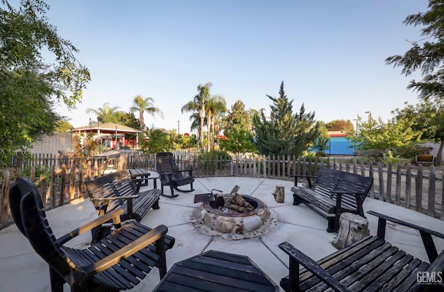 view of patio / terrace featuring a water view and a fire pit