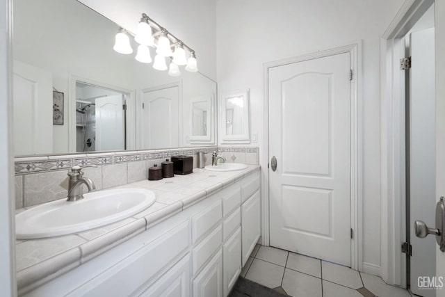 bathroom featuring a shower with door, vanity, backsplash, and tile patterned floors