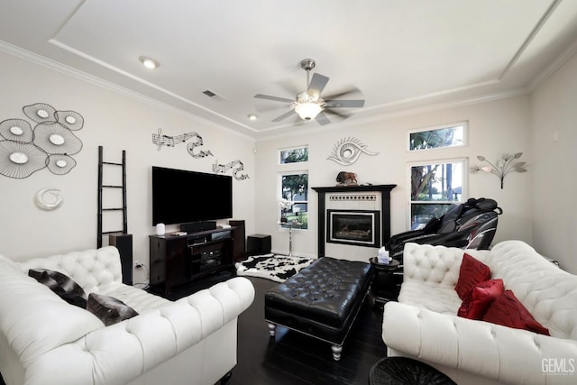 living room with ceiling fan and ornamental molding