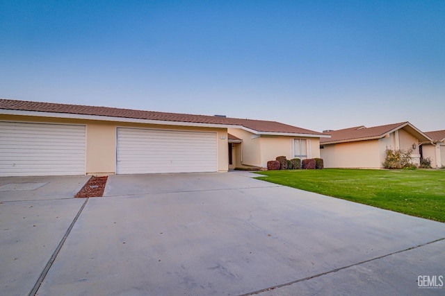 ranch-style house with a front yard and a garage