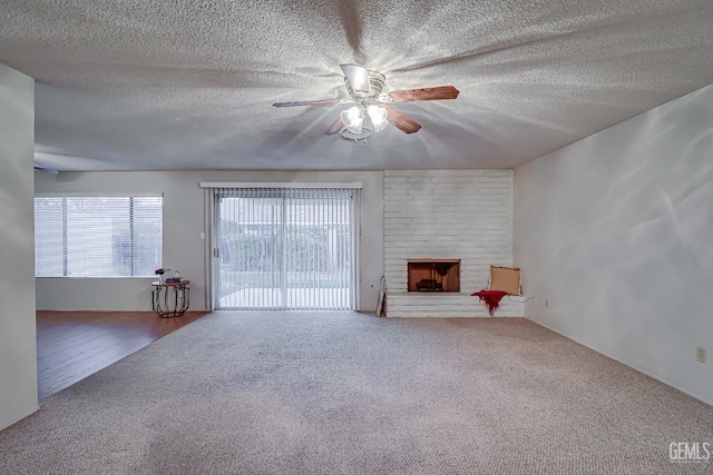 unfurnished living room with a fireplace, carpet, and ceiling fan