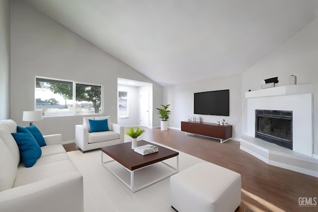 living area featuring a fireplace with raised hearth, high vaulted ceiling, baseboards, and wood finished floors