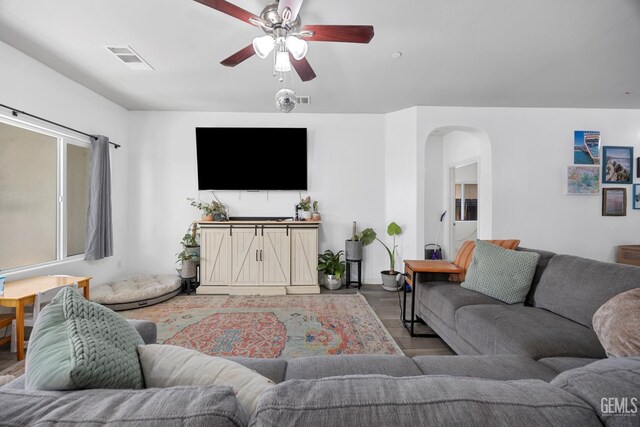 2004 Suncrisp Ln, Bakersfield, CA 93312 - living area with arched walkways, light wood finished floors, and ceiling fan