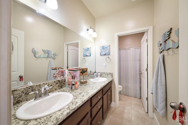 9109 Red Pine Dr, Shafter, CA 93263 - bathroom with tile patterned floors, a sink, double vanity, and toilet