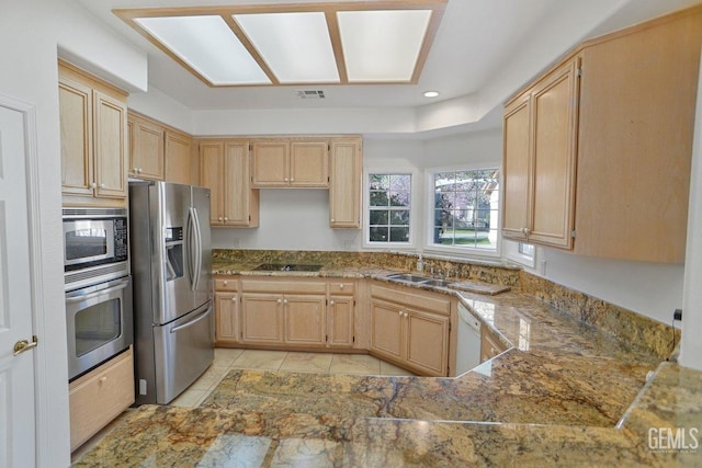 kitchen featuring stone countertops, visible vents, appliances with stainless steel finishes, light brown cabinetry, and recessed lighting