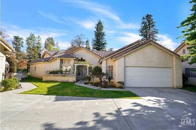 mediterranean / spanish-style home with stucco siding, concrete driveway, a garage, a tiled roof, and a front lawn