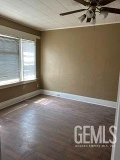 unfurnished room featuring baseboards, a ceiling fan, and wood finished floors