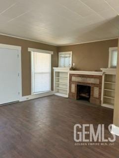 unfurnished living room featuring a fireplace and wood finished floors