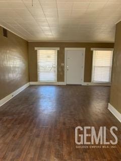 interior space featuring baseboards and wood finished floors