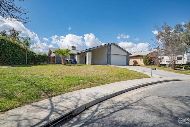 view of front of property with fence, driveway, stucco siding, a front lawn, and a garage