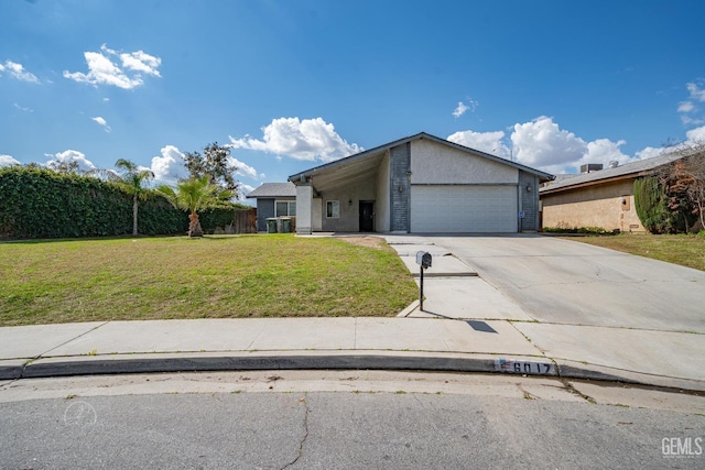 mid-century home with a front lawn, a garage, driveway, and stucco siding