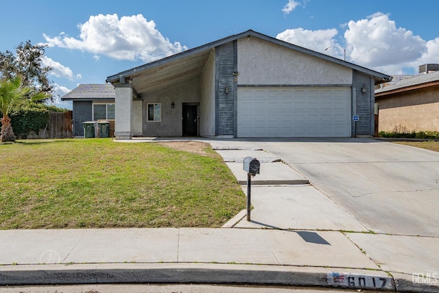 mid-century modern home with a front lawn, fence, concrete driveway, stucco siding, and an attached garage