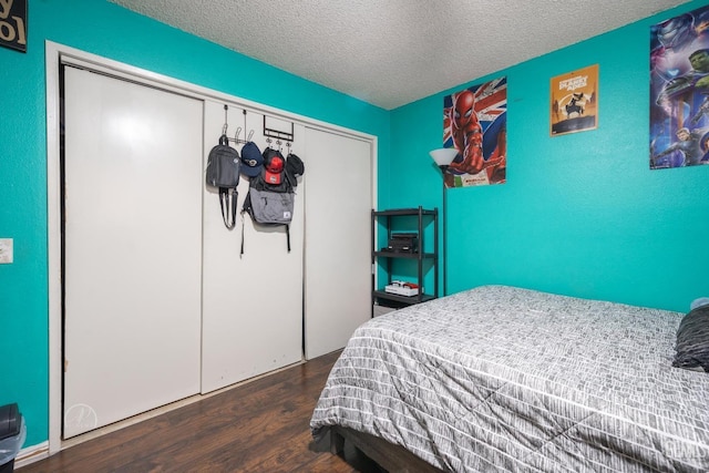 bedroom featuring a closet, a textured ceiling, and wood finished floors