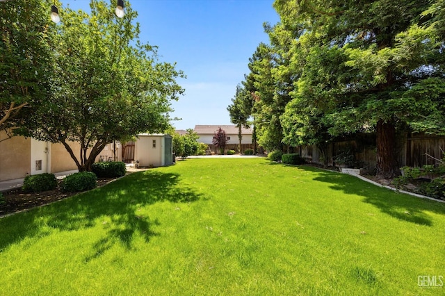 9508 Canyon Lake Ct, Bakersfield, CA 93312 - view of yard with a fenced backyard, a storage unit, and an outdoor structure