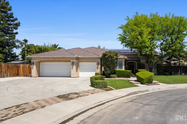 9508 Canyon Lake Ct, Bakersfield, CA 93312 - ranch-style home with fence, an attached garage, stucco siding, roof mounted solar panels, and concrete driveway