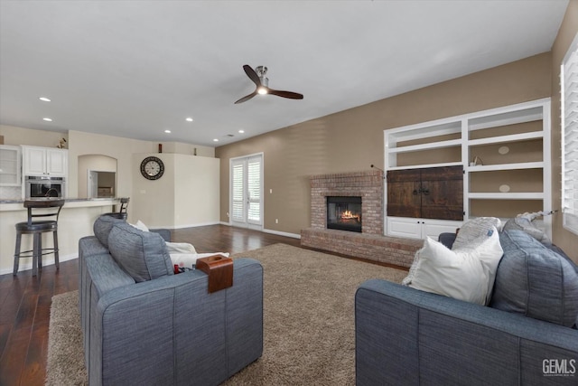 9508 Canyon Lake Ct, Bakersfield, CA 93312 - living room featuring a brick fireplace, dark wood-style flooring, a ceiling fan, and recessed lighting