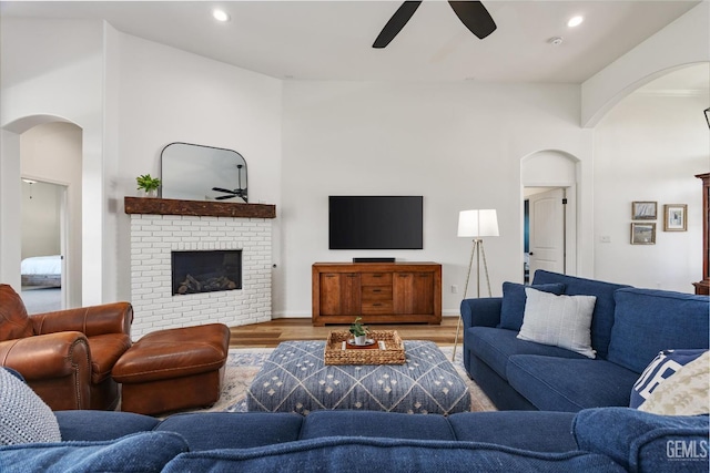 16711 Keystone Pl, Bakersfield, CA 93314 - living area featuring ceiling fan, arched walkways, wood finished floors, a brick fireplace, and recessed lighting
