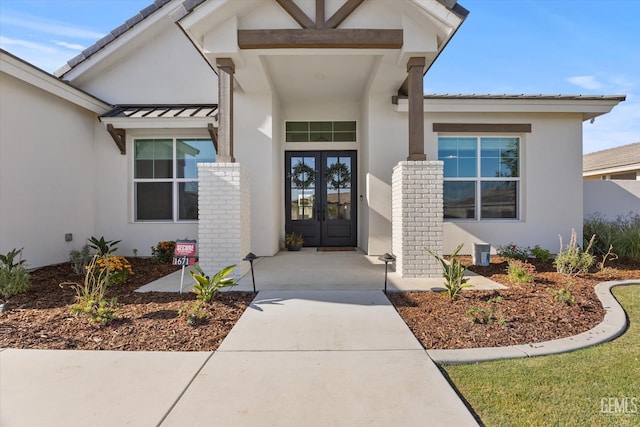 16711 Keystone Pl, Bakersfield, CA 93314 - view of exterior entry with french doors, stucco siding, a standing seam roof, and brick siding