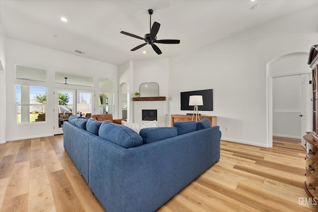 16711 Keystone Pl, Bakersfield, CA 93314 - living room featuring light wood-style flooring, a ceiling fan, a brick fireplace, recessed lighting, and french doors
