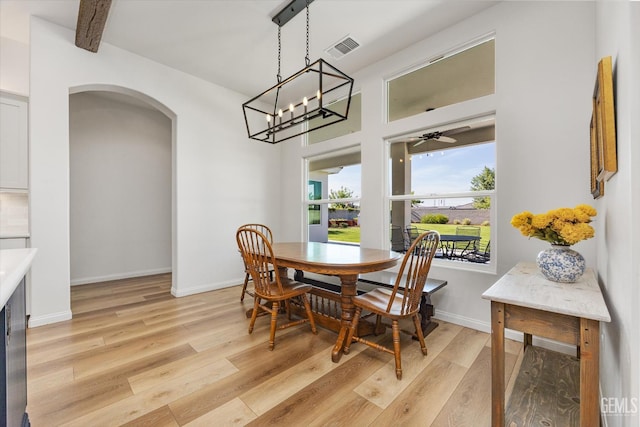 16711 Keystone Pl, Bakersfield, CA 93314 - dining area featuring arched walkways, light wood finished floors, a ceiling fan, and a chandelier