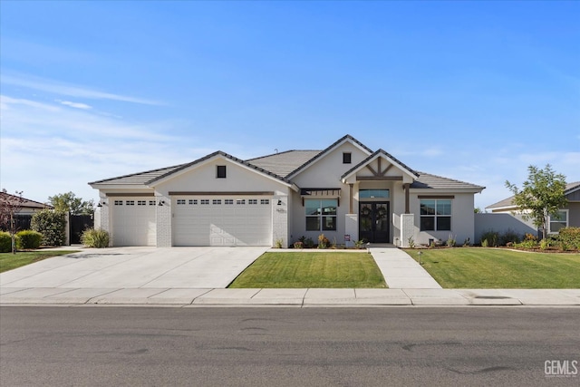16711 Keystone Pl, Bakersfield, CA 93314 - view of front of property with a garage, a front lawn, stucco siding, and driveway