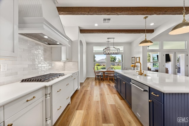16711 Keystone Pl, Bakersfield, CA 93314 - kitchen with stainless steel appliances, premium range hood, blue cabinets, beam ceiling, and light countertops