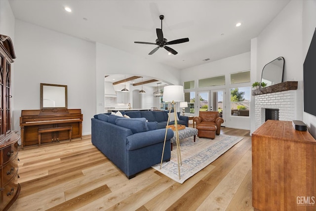 16711 Keystone Pl, Bakersfield, CA 93314 - living area with a fireplace, light wood-style floors, a ceiling fan, recessed lighting, and arched walkways