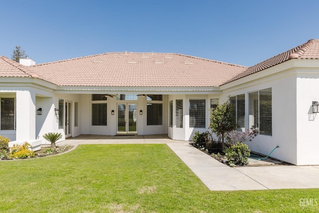 1715 Norwich Way, Bakersfield, CA 93311 - back of house featuring french doors, ceiling fan, stucco siding, a yard, and a tile roof