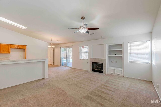 4810 Bluestone Dr, Bakersfield, CA 93311 - unfurnished living room with ceiling fan, light colored carpet, vaulted ceiling, and built in features