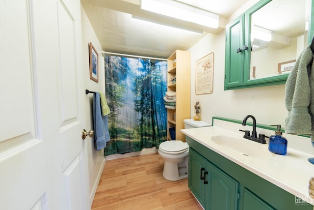 bathroom featuring vanity, curtained shower, toilet, and wood-type flooring